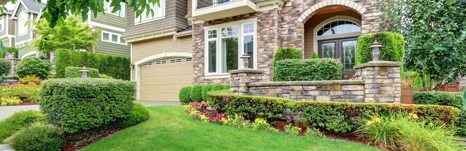 stone home with nice landscaping